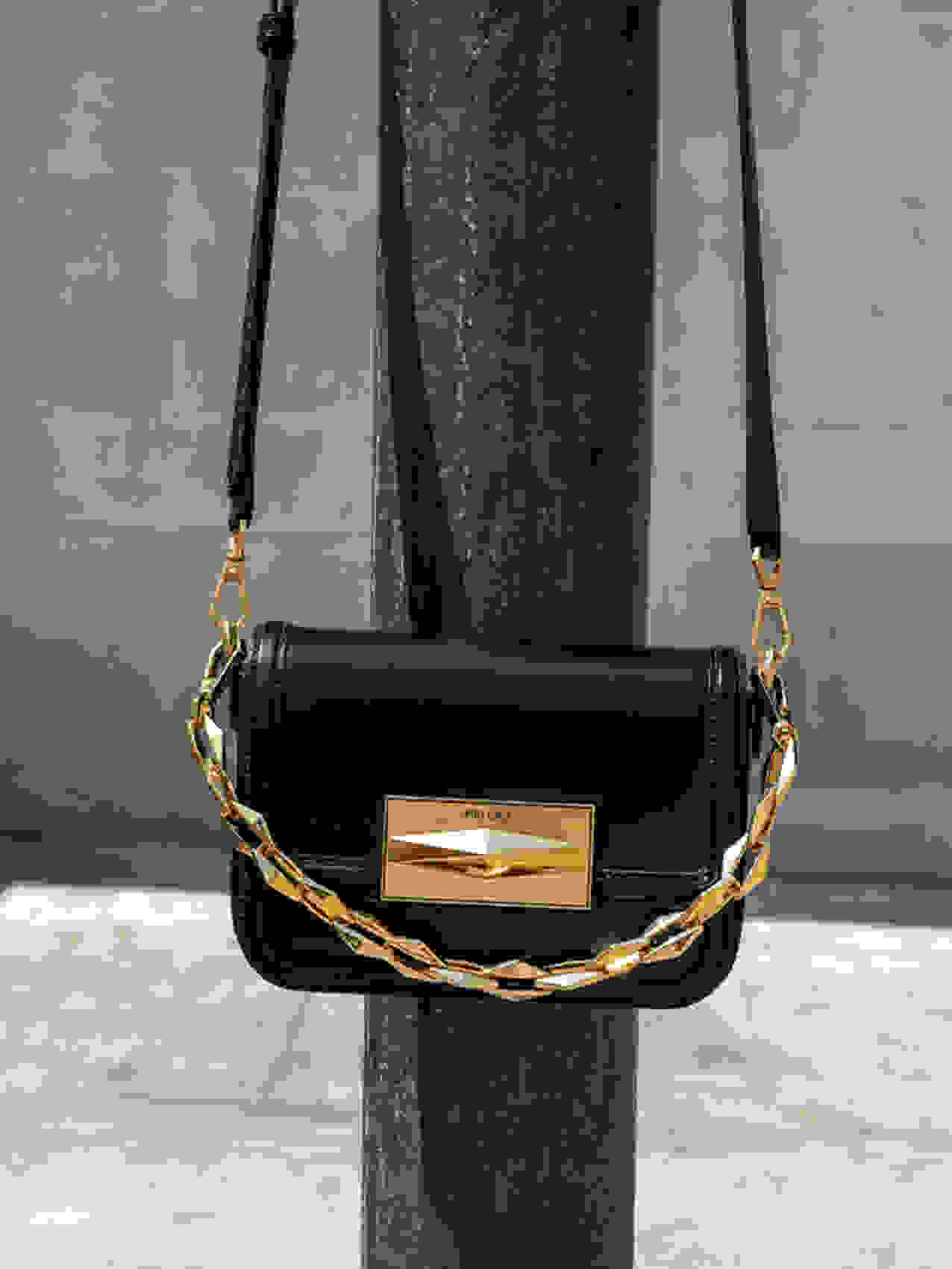 Jimmy Choo Diamond Crossbody handbag in black leather and brANZhed gold hardware.