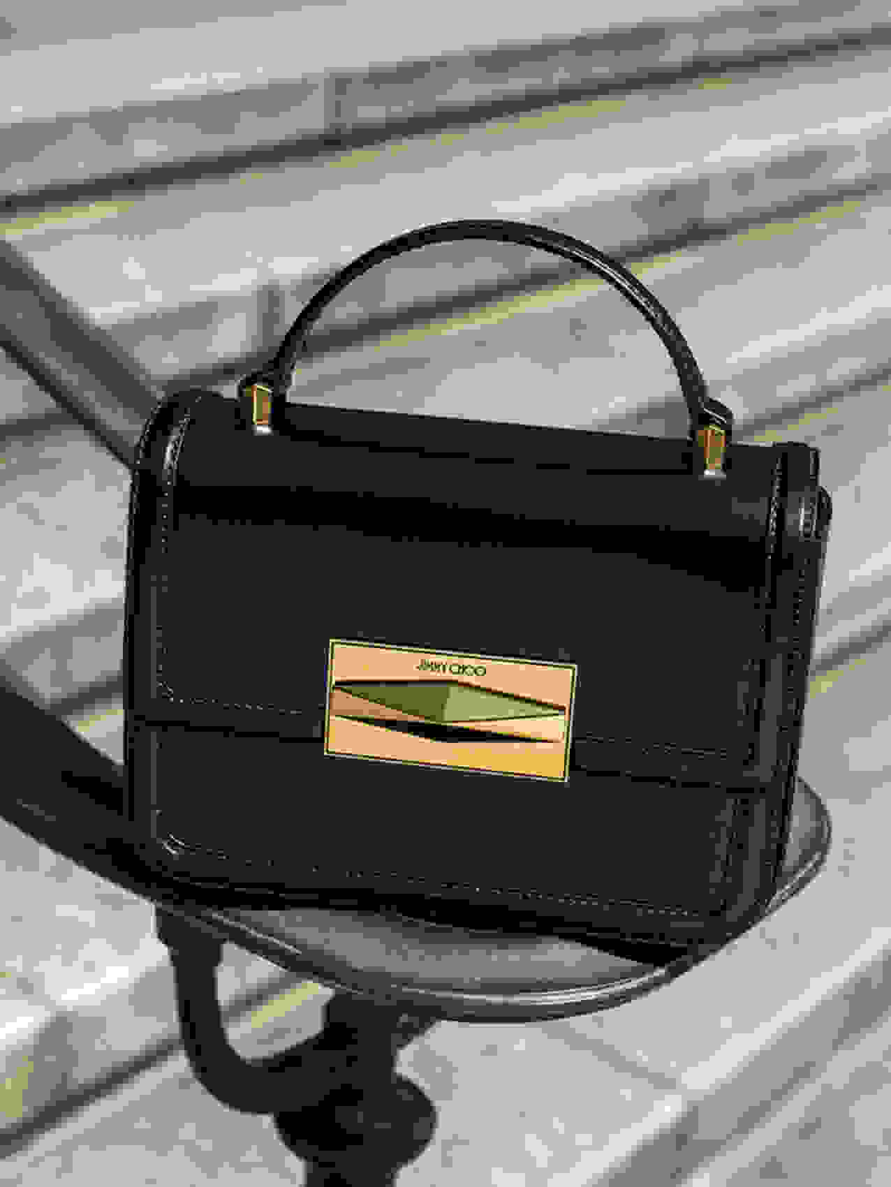 Jimmy Choo Diamond Crossbody handbag in black leather and brushed gold hardware.