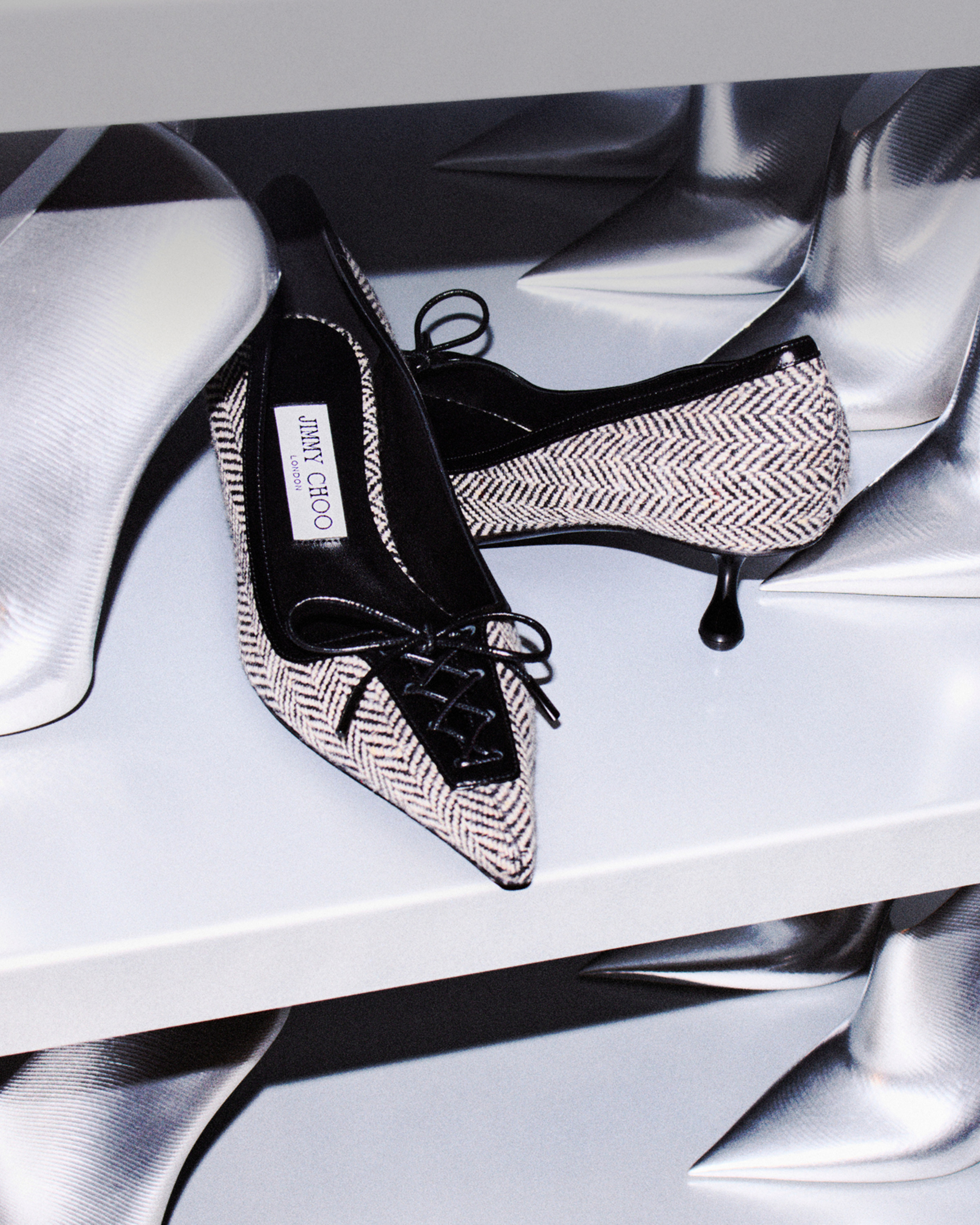 A linear over-the-knee silhouette presented in glossy eel-embossed leather.