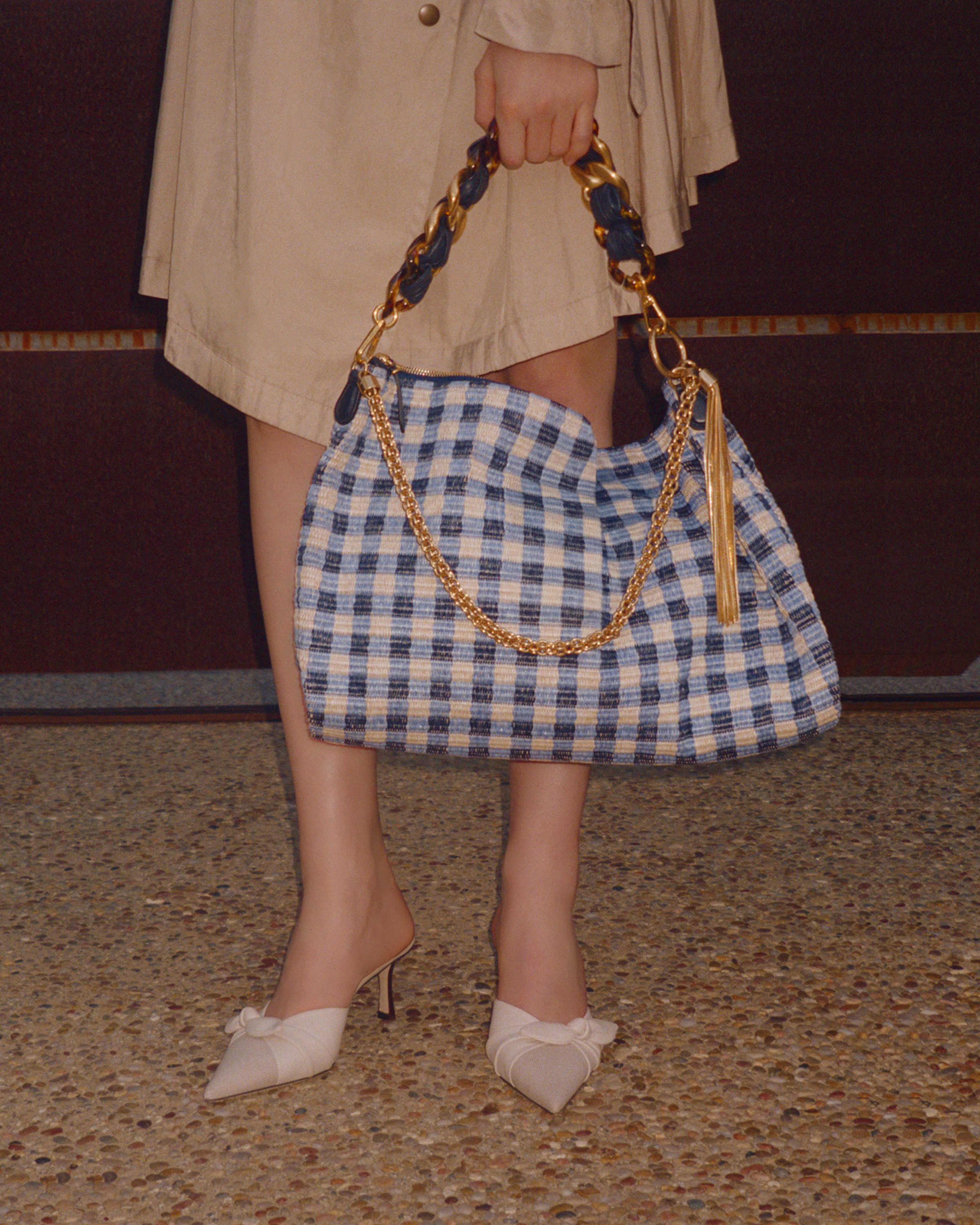 Model wearing black Jimmy Choo sunglasses, an oversized black leather jacket and lace top.