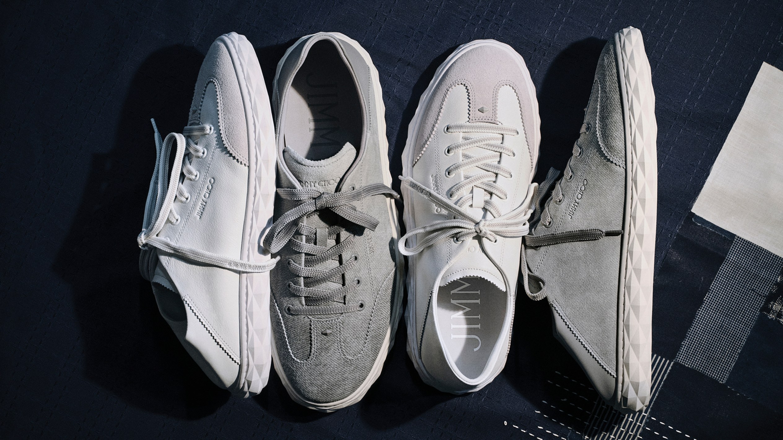 Model wearing a cream skirt and blouse, styled with a light yellow top-handle bag in a lush garden setting.