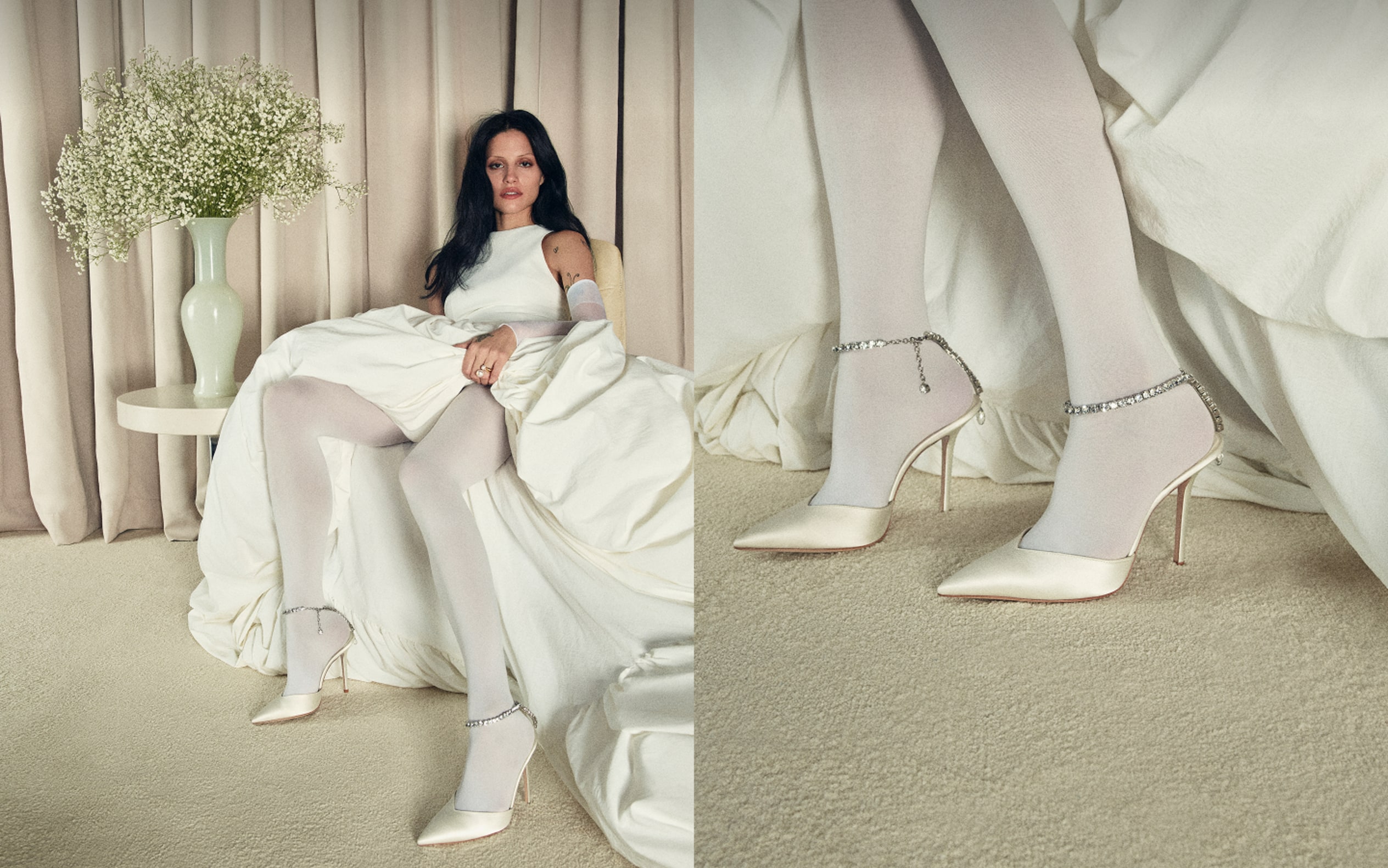 Model seated in ivory dress wearing pointed-toe heels with crystal ankle strap./ Ivory pointed-toe heels with crystal ankle strap detail.