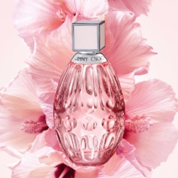 Jimmy Choo women&rsquo;s fragrance positioned in front of pink flower