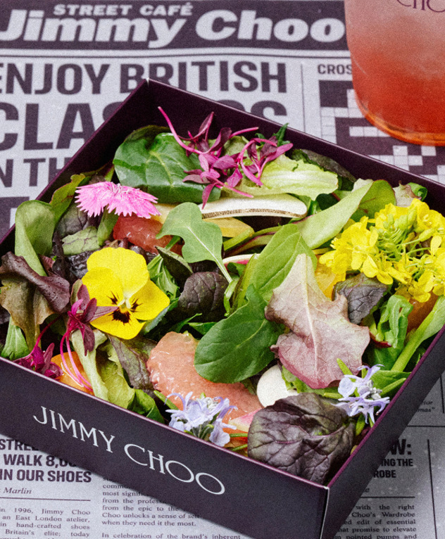 Branded Jimmy Choo salad bowl with flowers and greenery.