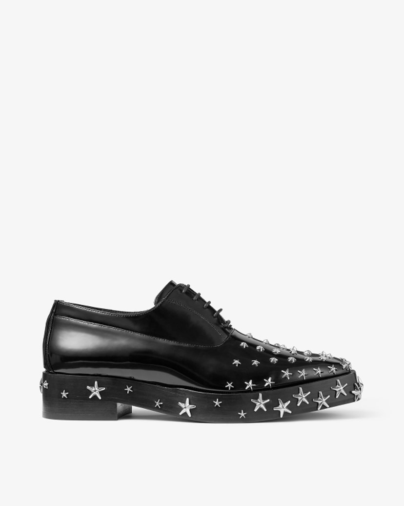 Black leather lace-up shoe with silver star stud embellishment and low block heel, shown in side profile.