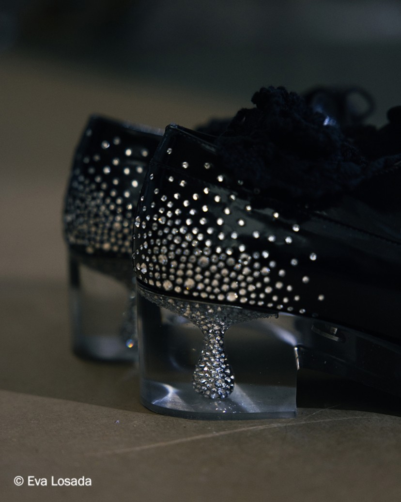 Black leather lace-up shoes with crystal-embellished and plexi heel, worn with sheer socks.