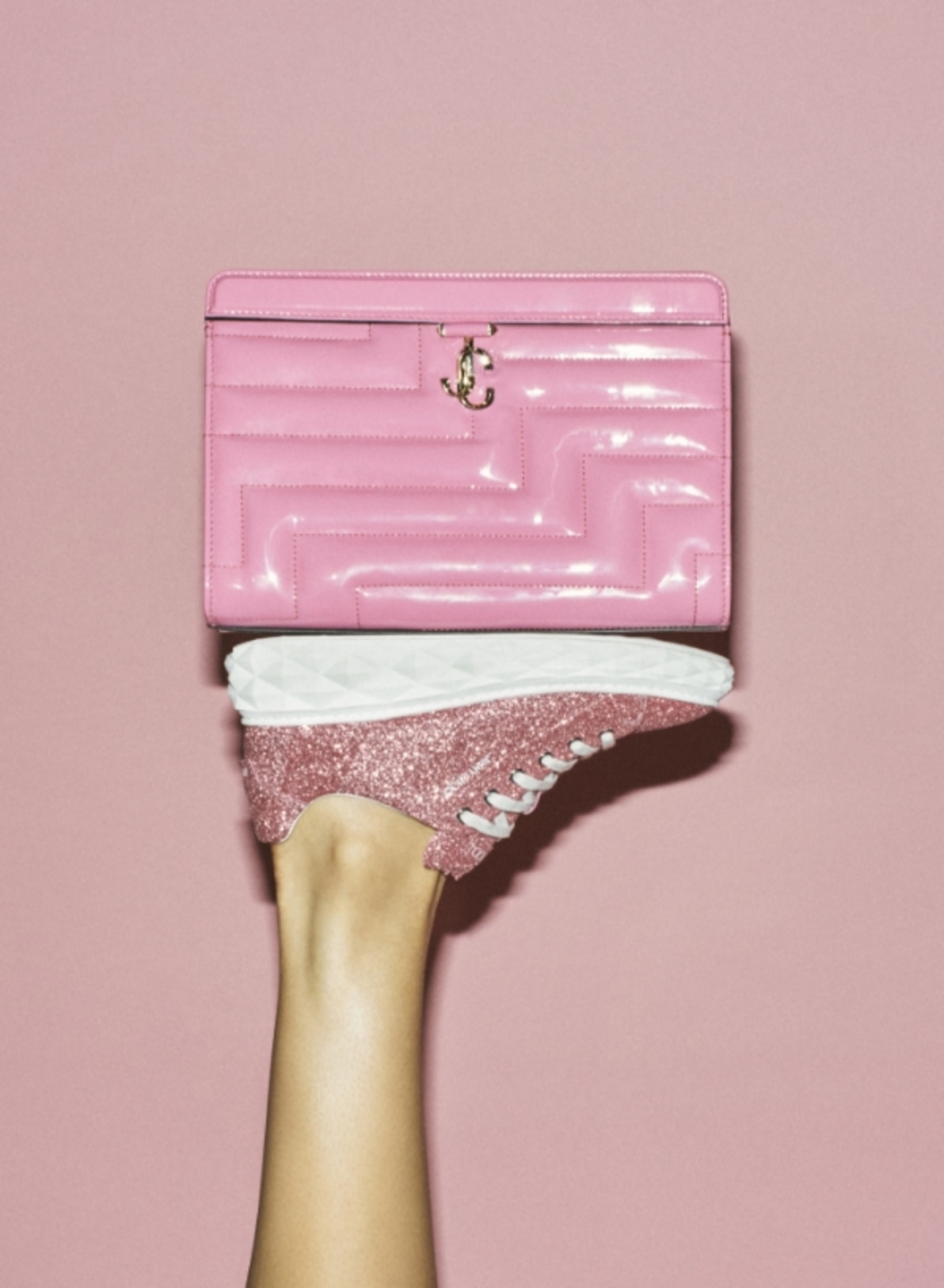 Jimmy Choo models style embellished heeled pumps and hold crystal-embellished mini bags