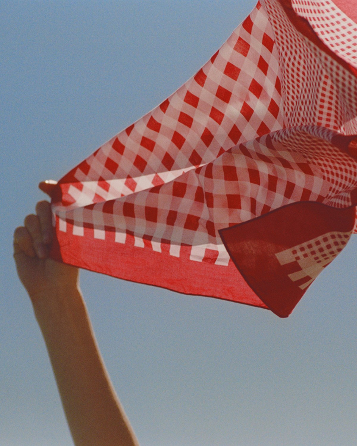 Model wearing black Jimmy Choo sunglasses, an oversized black leather jacket and lace top.