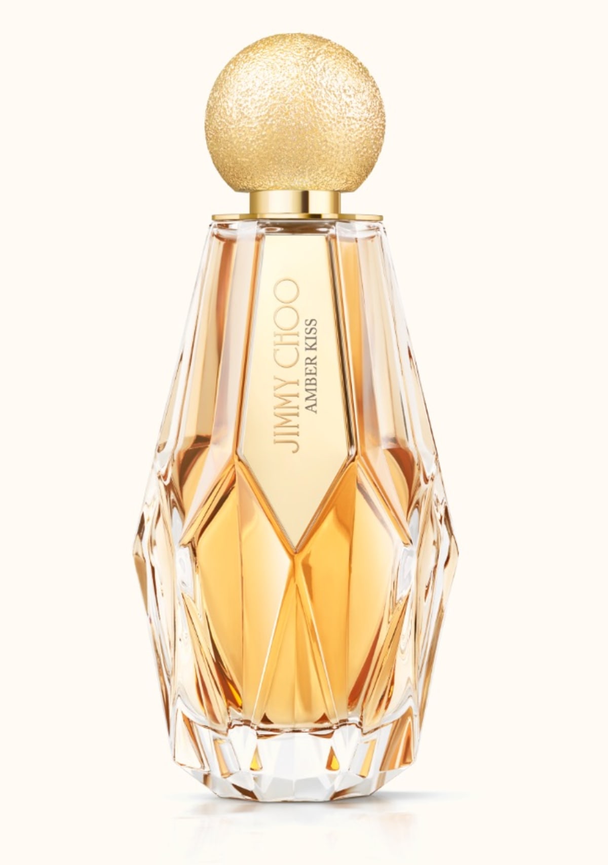 Jimmy Choo women&rsquo;s fragrance Amber Kiss in multi-faceted glass bottle with gold glitter cap