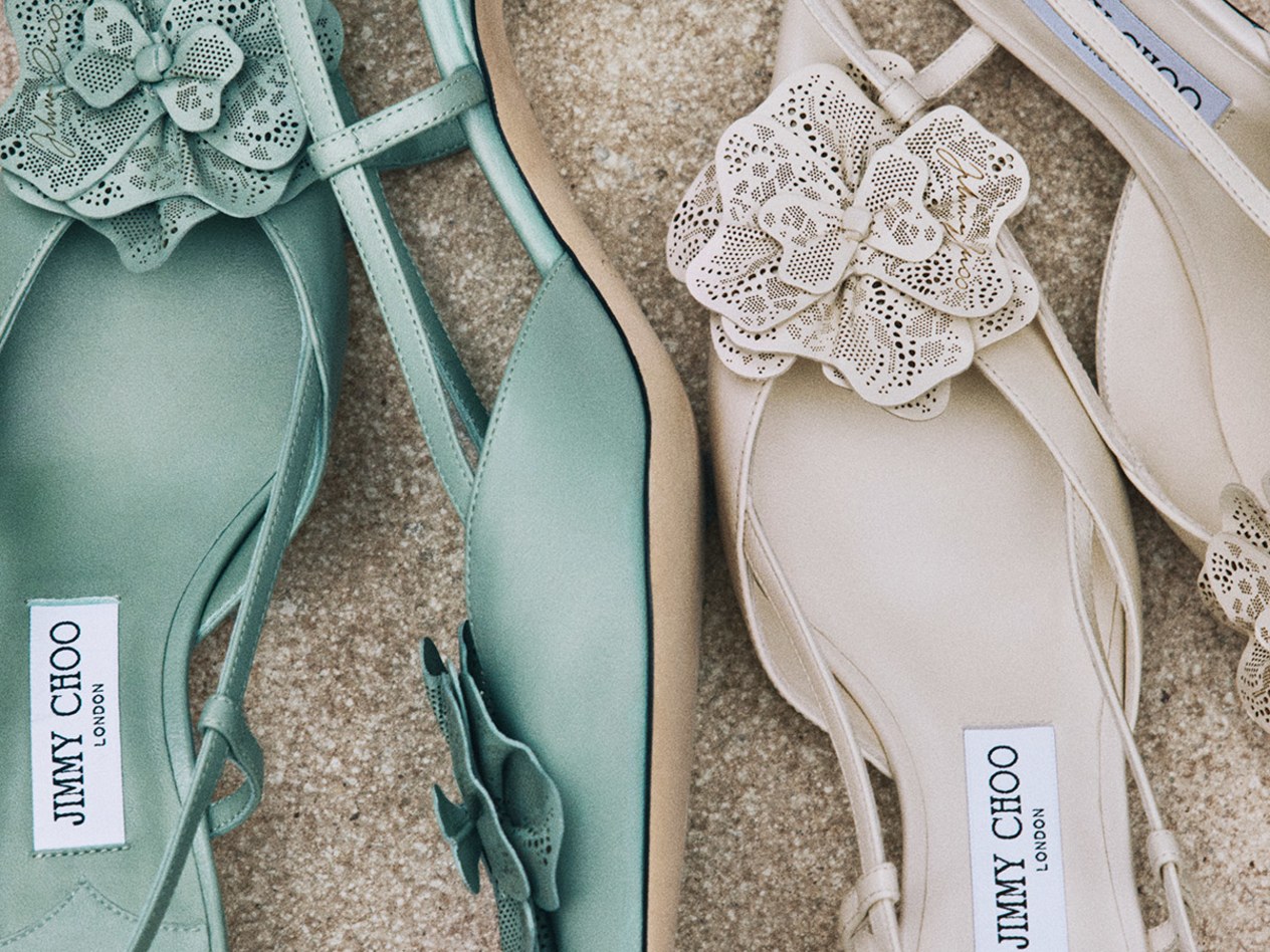 Model holding a white top-handle bridal bag, photographed in black and white.