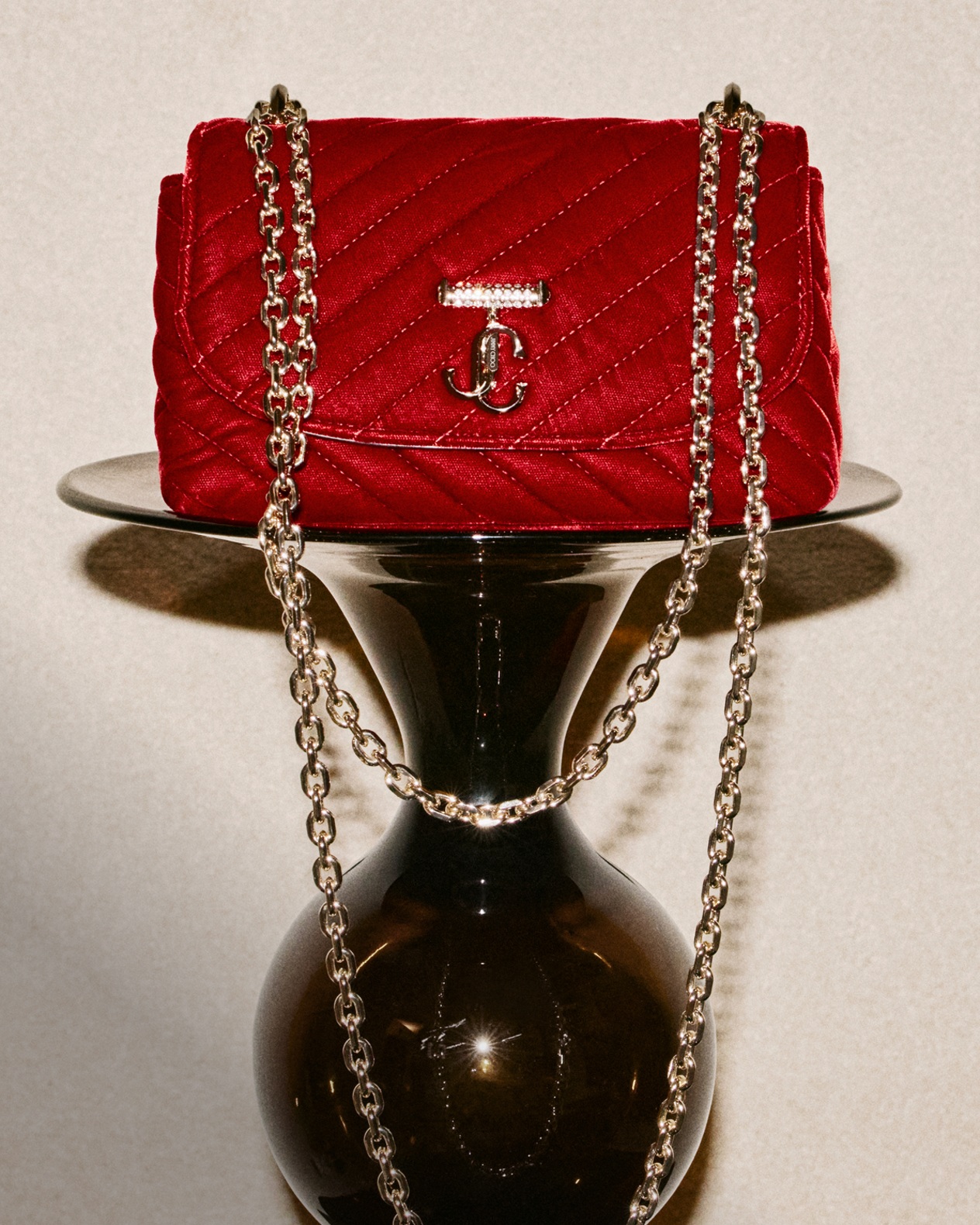 Pair of pointed-toe lace-up pumps, one in black leather and the other in leopard-print pony leather, displayed on a green textured surface.	