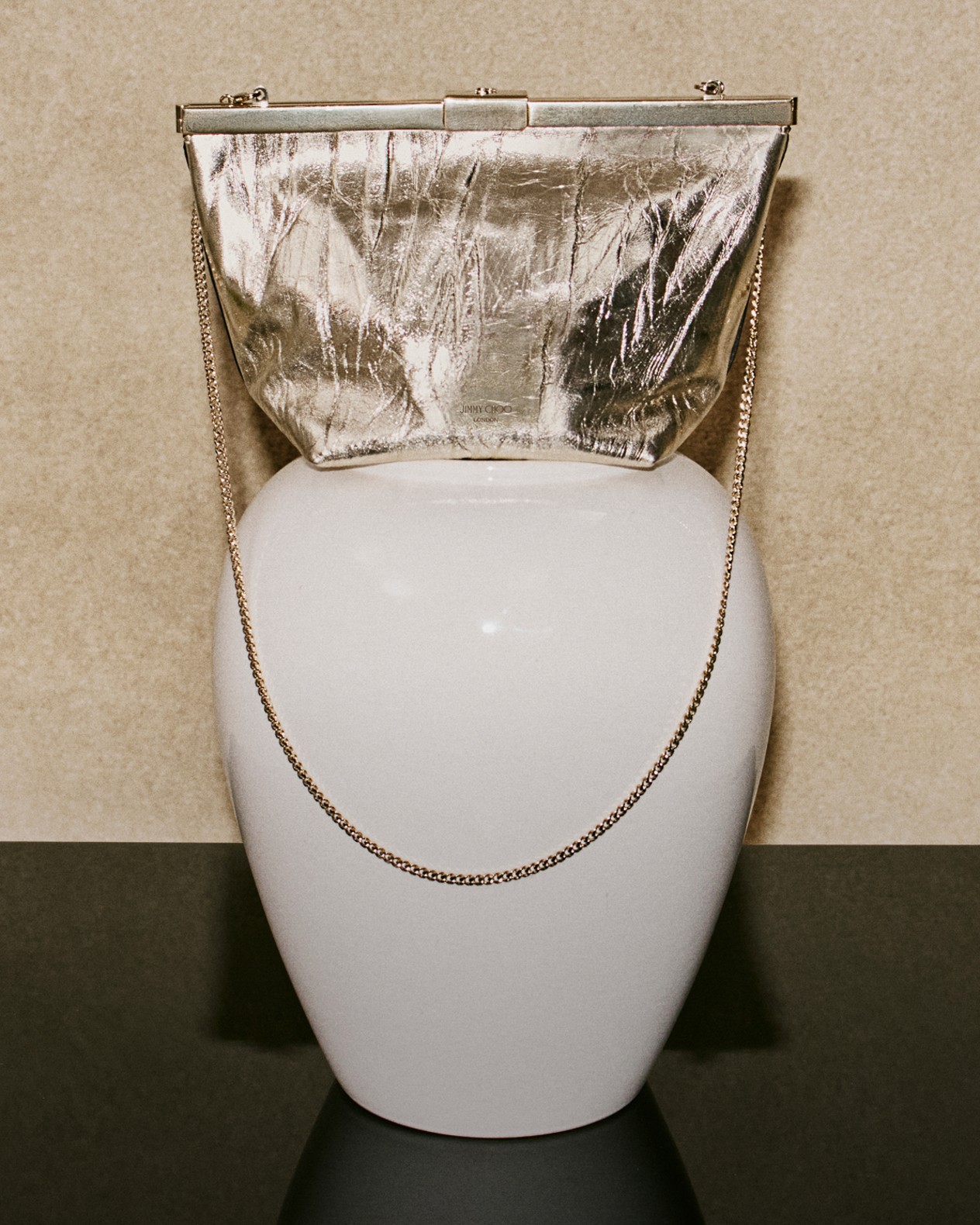 Gold floral jewellery pieces, including earrings and a bracelet with pearl accents, arranged on an elegant white and gold-rimmed plate.	