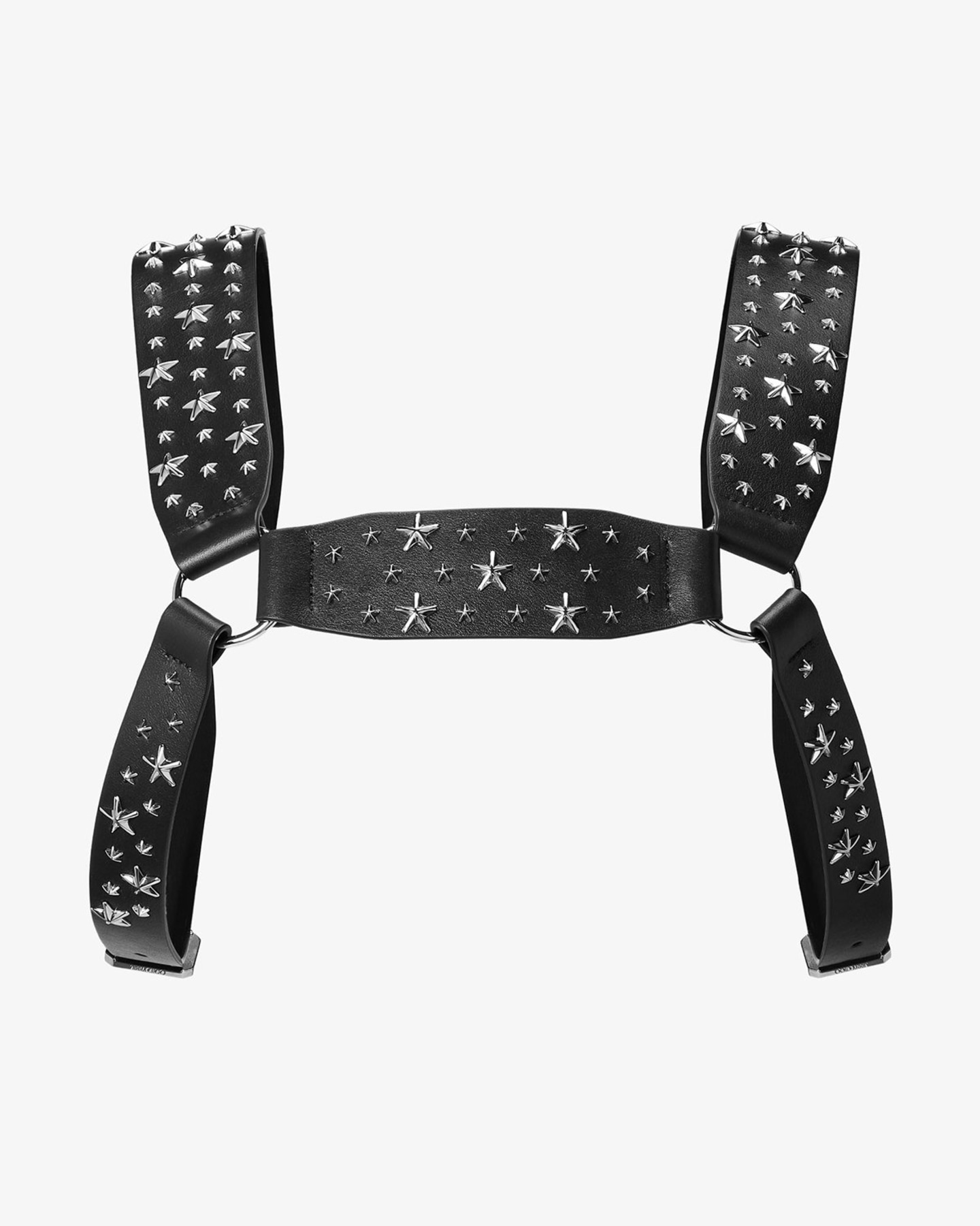 Close-up of a model wearing a black tailored jacket styled with a star-studded leather harness detail.