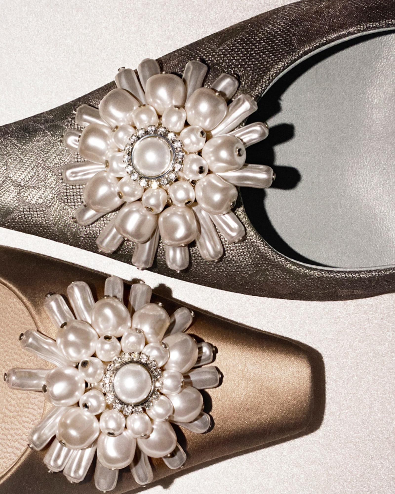 Satin champagne-coloured pointed-toe pump with a pearl and crystal floral embellishment and slim stiletto heel, shown from above