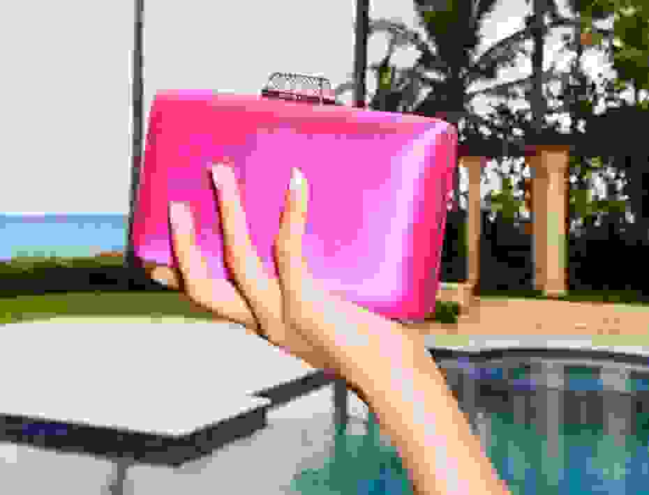 Jimmy Choo pink clutch with crystal clasp in models hand