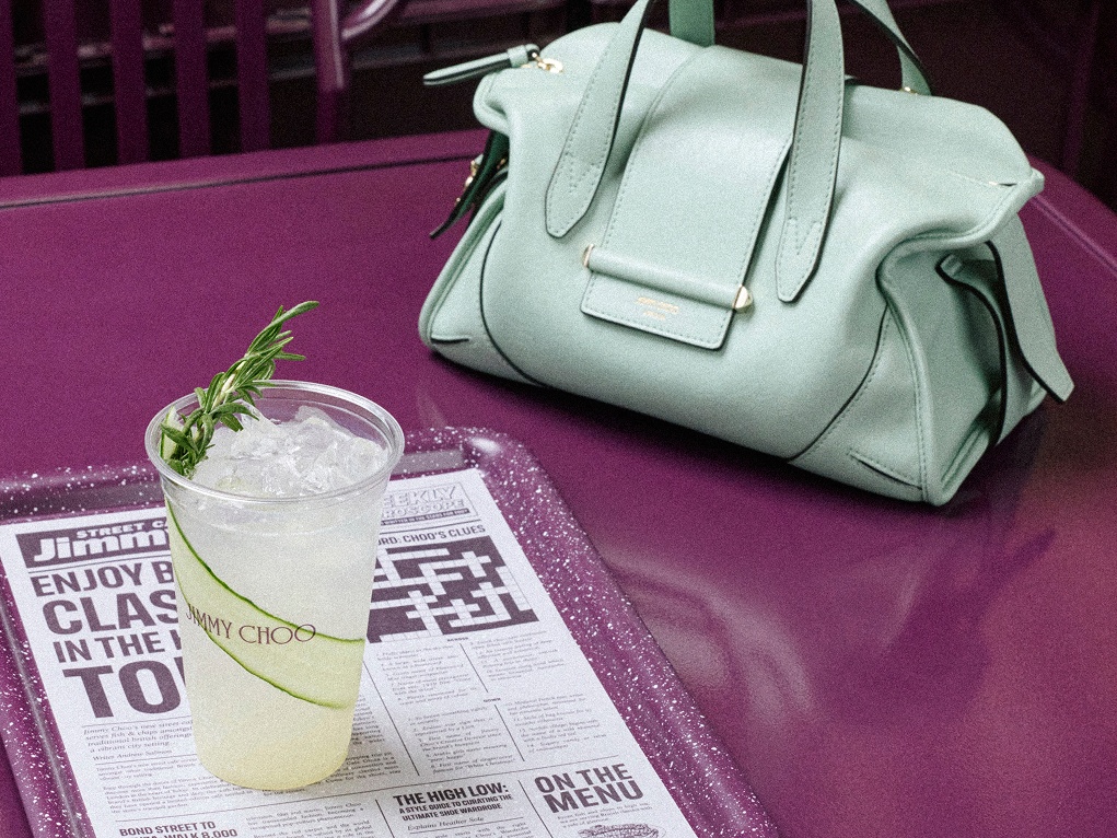Three iced Jimmy Choo drinks on a purple café table.