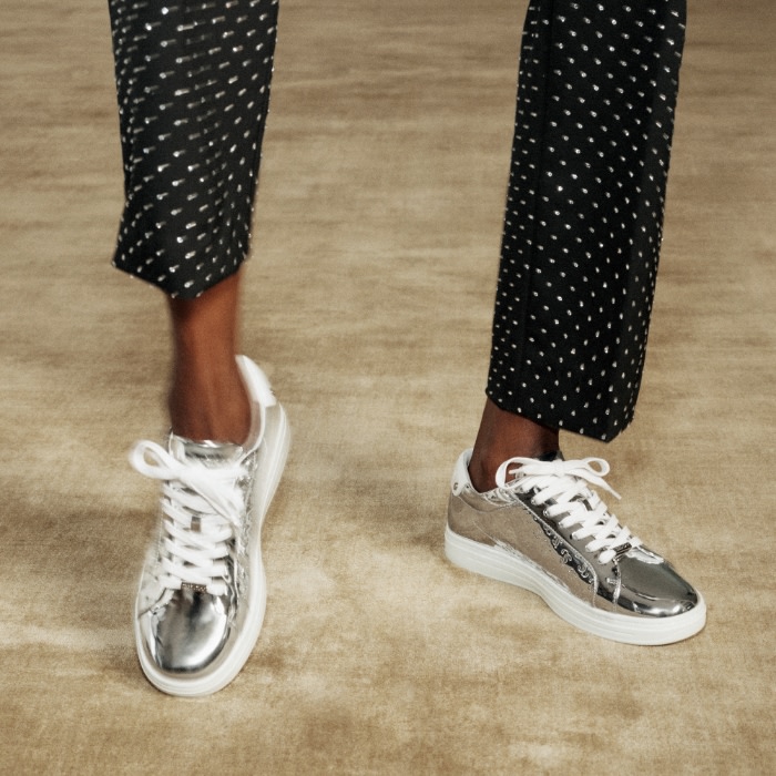 Jimmy Choo female model wearing Jimmy Choo Crystal Cuff bracelet and Pearl Cuff bracelet