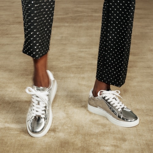 Jimmy Choo female model wearing Jimmy Choo Crystal Cuff bracelet and Pearl Cuff bracelet