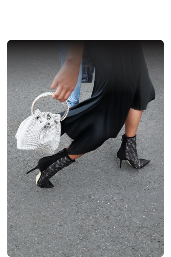 Jimmy Choo women's model with crystal-embellished bag and boots